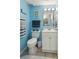 Charming bathroom with calming blue walls, a fluffy rug, and a white vanity for a fresh, clean feel at 1210 N Waccamaw Dr. # 1105, Murrells Inlet, SC 29576