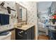 Cozy bathroom with patterned wallpaper, a dark vanity, and a mirror, adjacent to a bedroom at 1210 N Waccamaw Dr. # 1105, Murrells Inlet, SC 29576