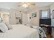 Inviting bedroom featuring a comfortable bed with blue accents, a ceiling fan, and a TV for relaxation at 1210 N Waccamaw Dr. # 1105, Murrells Inlet, SC 29576