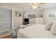 Spacious bedroom featuring a comfortable bed, complemented by a ceiling fan and a dresser for ample storage at 1210 N Waccamaw Dr. # 1105, Murrells Inlet, SC 29576
