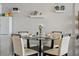 Dining room with glass table and seating for six, decorated with beach-themed decorations at 1210 N Waccamaw Dr. # 1105, Murrells Inlet, SC 29576