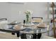 Stylishly set dining table with glass top and blue place settings, perfect for intimate meals at 1210 N Waccamaw Dr. # 1105, Murrells Inlet, SC 29576