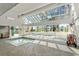 Well-lit indoor pool and jacuzzi area with a large skylight at 1210 N Waccamaw Dr. # 1105, Murrells Inlet, SC 29576