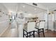 Bright, fully equipped kitchen with white cabinetry and breakfast bar connected to hallway at 1210 N Waccamaw Dr. # 1105, Murrells Inlet, SC 29576