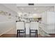 Well-lit kitchen with white cabinetry, stainless steel appliances, and breakfast bar seating at 1210 N Waccamaw Dr. # 1105, Murrells Inlet, SC 29576