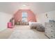 Bright bedroom with pink accent wall, window seat, and carpet floors at 140 Avondale Dr., Myrtle Beach, SC 29588