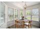 Bright dining area features natural light with multiple windows and a modern chandelier with seating for four at 140 Avondale Dr., Myrtle Beach, SC 29588