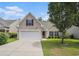 Charming home featuring a two-car garage, well-kept lawn, and mature tree providing ample shade at 140 Avondale Dr., Myrtle Beach, SC 29588
