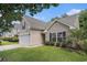 Inviting home with lush green lawn, a two-car garage, complemented by manicured shrubs at 140 Avondale Dr., Myrtle Beach, SC 29588