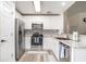 Modern kitchen boasts stainless steel appliances, granite countertops, and white cabinetry at 140 Avondale Dr., Myrtle Beach, SC 29588