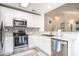 Modern kitchen boasts stainless steel appliances, granite countertops, and decorative tile backsplash at 140 Avondale Dr., Myrtle Beach, SC 29588