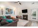 Inviting living room with a cozy fireplace, plush seating, and modern ceiling fan at 140 Avondale Dr., Myrtle Beach, SC 29588