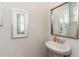 Clean, well-lit half-bathroom with a white pedestal sink, framed mirrors, and neutral decor at 1403 Nokota Dr., Conway, SC 29526