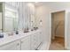 Elegant bathroom with a double sink vanity, stylish decor, and a doorway leading to a closet at 1403 Nokota Dr., Conway, SC 29526