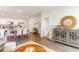 Open dining room with modern table, decorative sideboard, and view into the kitchen and living areas at 1403 Nokota Dr., Conway, SC 29526