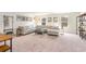 Spacious living room showcases a large sectional sofa, neutral decor, and ample natural light from surrounding windows at 1403 Nokota Dr., Conway, SC 29526