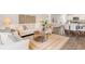 Open-concept living space with stylish decor, wood floors, and a view of the dining area and kitchen at 1403 Nokota Dr., Conway, SC 29526