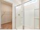 Modern bathroom featuring a glass-enclosed shower with white tile and a view of the walk-in closet at 1403 Nokota Dr., Conway, SC 29526