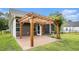 View of the back patio with pergola, concrete flooring, and access to the home's screened in porch at 1476 Burriss Rd., Conway, SC 29526