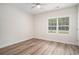 Bedroom featuring wood flooring, a ceiling fan, and large window with blinds at 1476 Burriss Rd., Conway, SC 29526