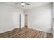 Bedroom with wood flooring, ceiling fan, white trim, and two white doors at 1476 Burriss Rd., Conway, SC 29526