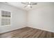 Bedroom with ceiling fan, wood flooring, and a window with natural light at 1476 Burriss Rd., Conway, SC 29526
