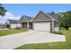 Well-kept one-story house with gray siding, a manicured lawn, and a spacious concrete driveway at 1476 Burriss Rd., Conway, SC 29526