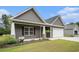 The home's front exterior features beautiful landscaping, a two car garage, and complimentary paint scheme at 1476 Burriss Rd., Conway, SC 29526