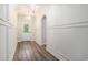 Bright hallway featuring elegant trim, wood flooring, and stylish light fixtures at 1476 Burriss Rd., Conway, SC 29526