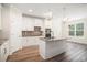 Bright kitchen with white cabinets, granite countertops, stainless appliances, and kitchen island at 1476 Burriss Rd., Conway, SC 29526