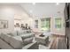 Bright living room with vaulted ceiling, hardwood floors, brick fireplace, and access to the outdoors at 1476 Burriss Rd., Conway, SC 29526