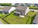 Spacious backyard with green grass, an iron fence, a screened porch, and a patio area, perfect for outdoor living at 148 Long Leaf Pine Dr., Conway, SC 29526