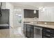 Kitchen island with stainless steel appliances and granite counters, offering a view into the dining area with modern lighting at 148 Long Leaf Pine Dr., Conway, SC 29526
