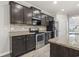 Modern kitchen features granite counters, stainless steel appliances, dark wood cabinets and tile backsplash at 148 Long Leaf Pine Dr., Conway, SC 29526