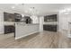 Open kitchen with dark cabinetry, granite countertops, a breakfast bar, and modern appliances, flowing into the dining area at 148 Long Leaf Pine Dr., Conway, SC 29526