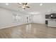 Open-concept living area featuring woodgrain floors, neutral paint, and modern ceiling fan at 148 Long Leaf Pine Dr., Conway, SC 29526
