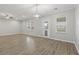 Spacious living room boasts woodgrain flooring, modern lighting, and lots of natural light at 148 Long Leaf Pine Dr., Conway, SC 29526