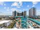 High-angle view of the resort, ocean and waterslides, including palm trees, walkways, and multiple resort buildings at 1501 Ocean Blvd. S # 1249, Myrtle Beach, SC 29577