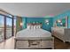 Bright bedroom with king bed, wood flooring, and a balcony overlooking the city at 1501 Ocean Blvd. S # 1249, Myrtle Beach, SC 29577