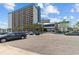 Exterior view of the Landmark Resort, showcasing the building architecture, parking area, and convenient signage at 1501 Ocean Blvd. S # 1249, Myrtle Beach, SC 29577