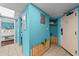 Hallway with blue walls leads to a bedroom and features a unique decorative fence accent at 1501 Ocean Blvd. S # 1249, Myrtle Beach, SC 29577