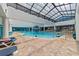 Large indoor pool with fountain, glass roof and lounge chairs, creating an inviting aquatic atmosphere at 1501 Ocean Blvd. S # 1249, Myrtle Beach, SC 29577