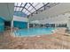 Indoor pool with a glass roof and brick flooring, offering year-round enjoyment and natural light at 1501 Ocean Blvd. S # 1249, Myrtle Beach, SC 29577