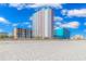 View of multiple resorts from the beach on a partly cloudy day at 1605 S Ocean Blvd. S # 105, Myrtle Beach, SC 29577