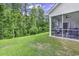 Spacious backyard with well-maintained lawn and screened-in porch, backing onto green space at 191 Marley Blue Dr., Little River, SC 29566