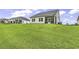 Expansive backyard view showcasing the lush green lawn extending to the house with a screened porch at 191 Marley Blue Dr., Little River, SC 29566