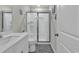 Well-lit bathroom features a shower with glass doors and white vanity with grey decorative seafaring accents at 191 Marley Blue Dr., Little River, SC 29566