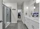 Modern bathroom with a glass shower, double sink vanity, and tiled floors, offering a spa-like experience at 191 Marley Blue Dr., Little River, SC 29566