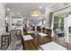Open dining area showcasing a wooden table, decor and seamless connection to the kitchen and outdoor patio at 191 Marley Blue Dr., Little River, SC 29566