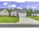 Charming single-story home with a well-manicured lawn and attached two-car garage at 191 Marley Blue Dr., Little River, SC 29566